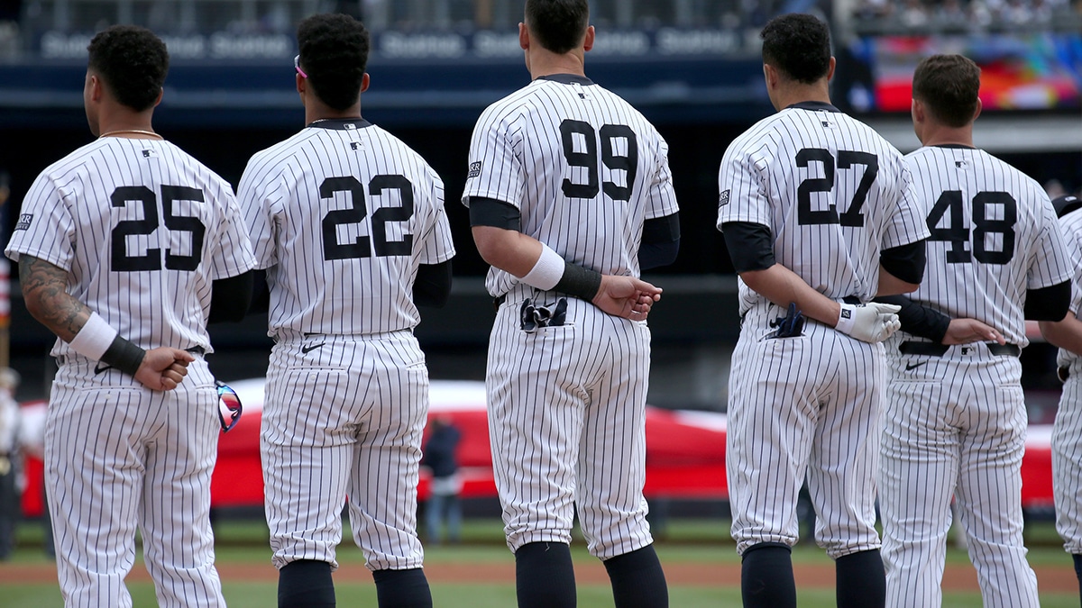 New York Yankees second baseman Gleyber Torres (25) and right fielder Juan Soto (22) and center fielder Aaron Judge (99) and designated hitter Giancarlo Stanton (27) and first baseman Anthony Rizzo (48) stand for the national anthem before an opening day game against the Toronto Blue Jays at Yankee Stadium.