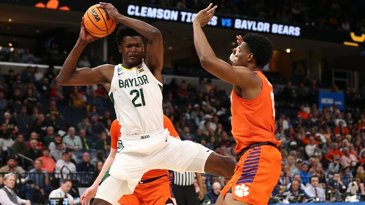 Baylor Bears center Yves Missi (21) controls the ball against Clemson Tigers forward RJ Godfrey (10) in the second half in the second round of the 2024 NCAA Tournament at FedExForum.