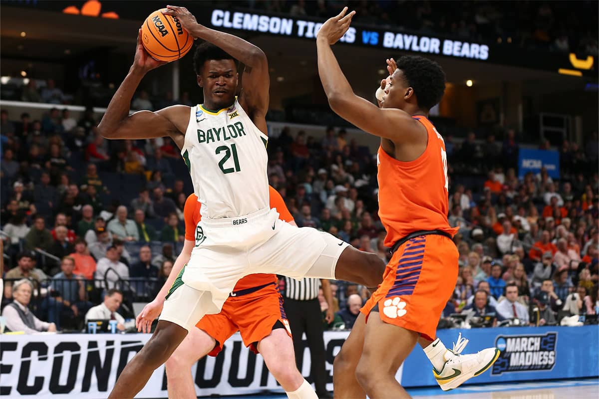 Baylor Bears center Yves Missi (21) controls the ball against Clemson Tigers forward RJ Godfrey (10) in the second half in the second round of the 2024 NCAA Tournament at FedExForum.