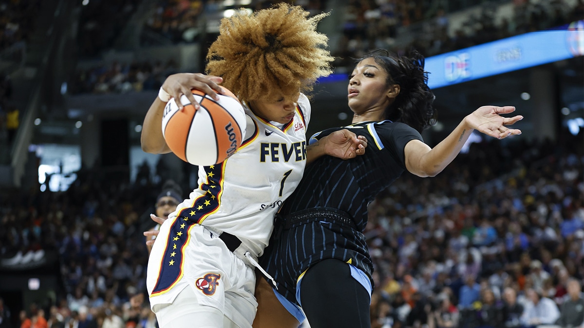 Jun 23, 2024; Chicago, Illinois, USA; Indiana Fever forward NaLyssa Smith (1) drives to the basket against Chicago Sky forward Angel Reese (5) during the first half at Wintrust Arena. Mandatory Credit: Kamil Krzaczynski-USA TODAY Sports