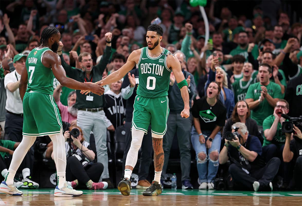 Boston Celtics forward Jayson Tatum (0) celebrates with guard Jaylen Brown (7) after a play against the Dallas Mavericks during the second quarter in game five of the 2024 NBA Finals at TD Garden.