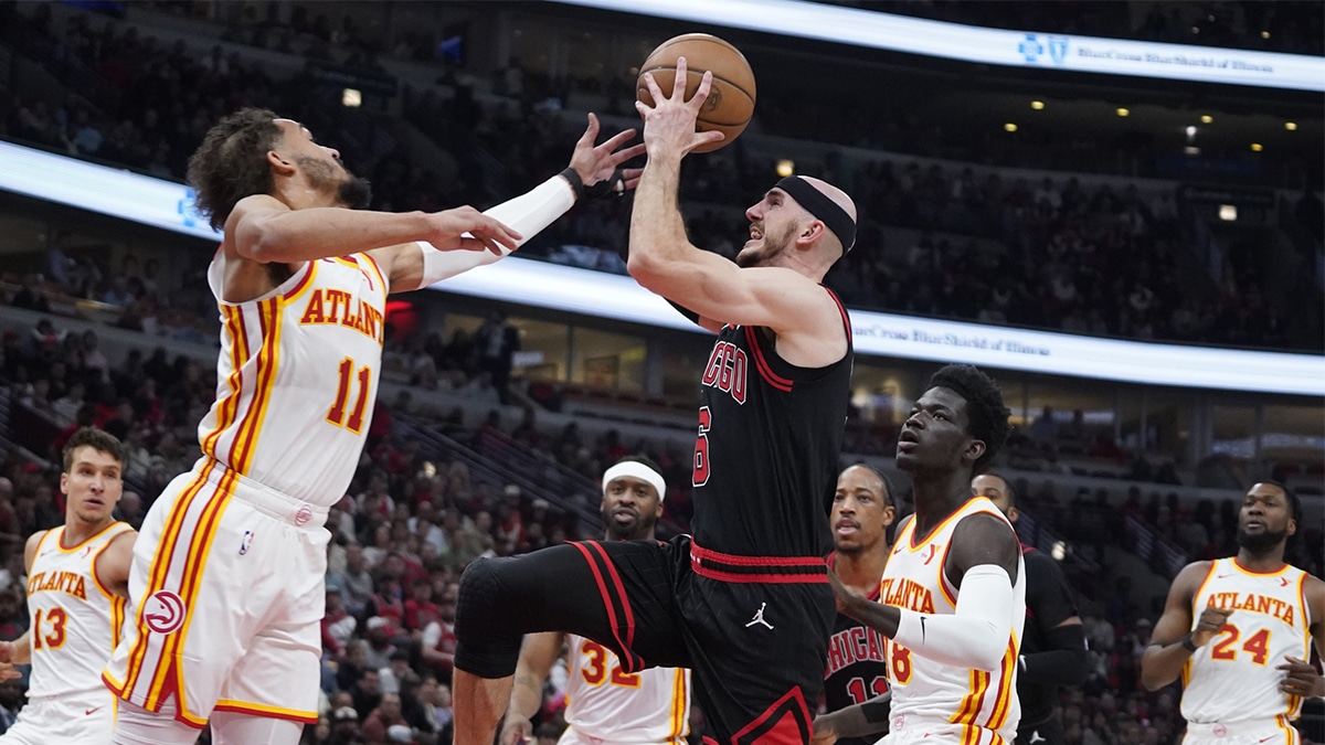 Apr 17, 2024; Chicago, Illinois, USA; Atlanta Hawks guard Trae Young (11) defends Chicago Bulls guard Alex Caruso (6) during the first quarter during a play-in game of the 2024 NBA playoffs at United Center. Mandatory Credit: David Banks-USA TODAY Sports