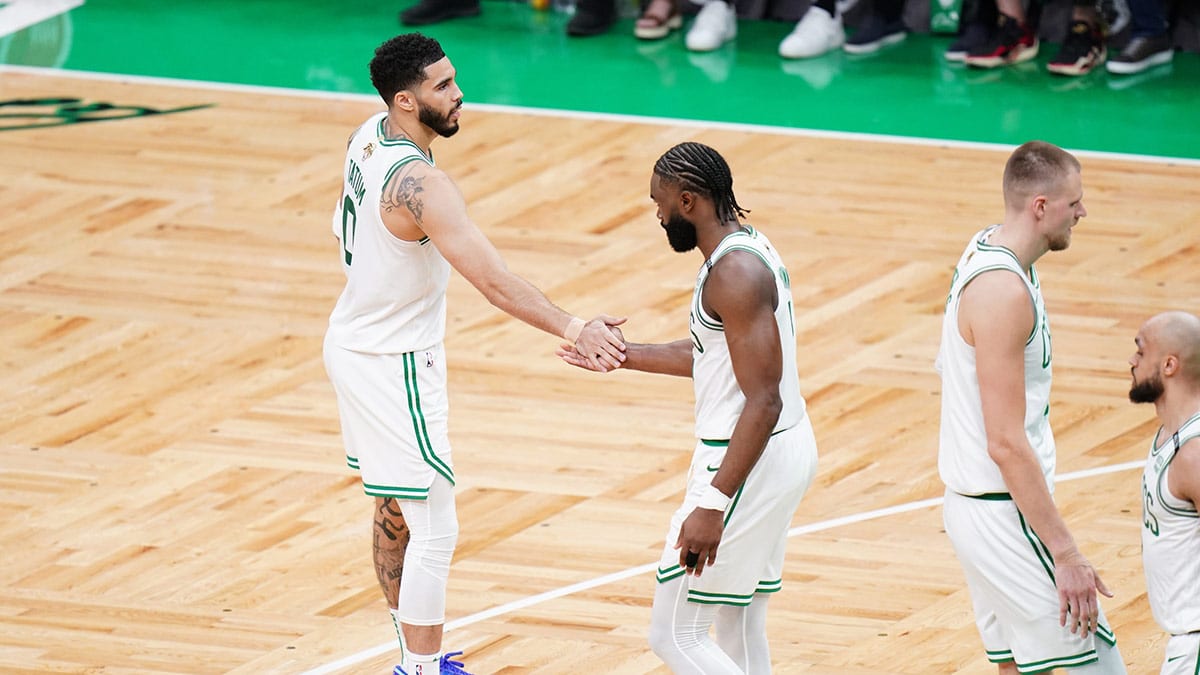 Boston Celtics guard Jaylen Brown (7) and forward Jayson Tatum (0) react in the second quarter against the Dallas Mavericks during game one of the 2024 NBA Finals at TD Garden. 
