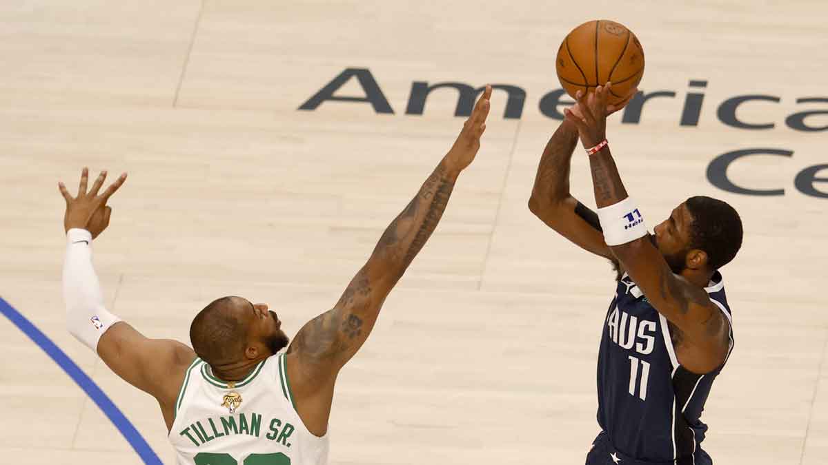 Jun 12, 2024; Dallas, Texas, USA; Dallas Mavericks guard Kyrie Irving (11) shoots against Boston Celtics forward Xavier Tillman (26) during the first quarter in game three of the 2024 NBA Finals at American Airlines Center. Mandatory Credit: Peter Casey-USA TODAY Sports