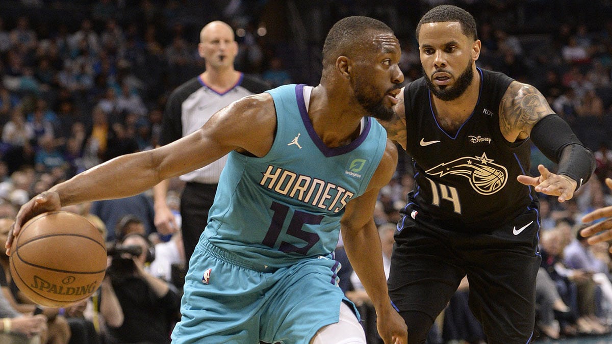 Charlotte Hornets guard Kemba Walker (15) drives in against Orlando Magic D.J. Augustin (14) during the second half at the Spectrum Center. Magic won 122-114.