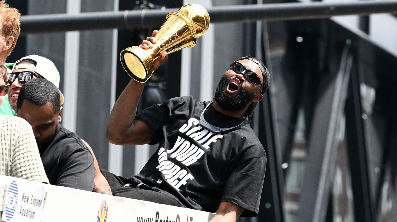 Boston Celtics guard Jaylen Brown (7) holds the MVP trophy during the 2024 NBA Championship parade in Boston.