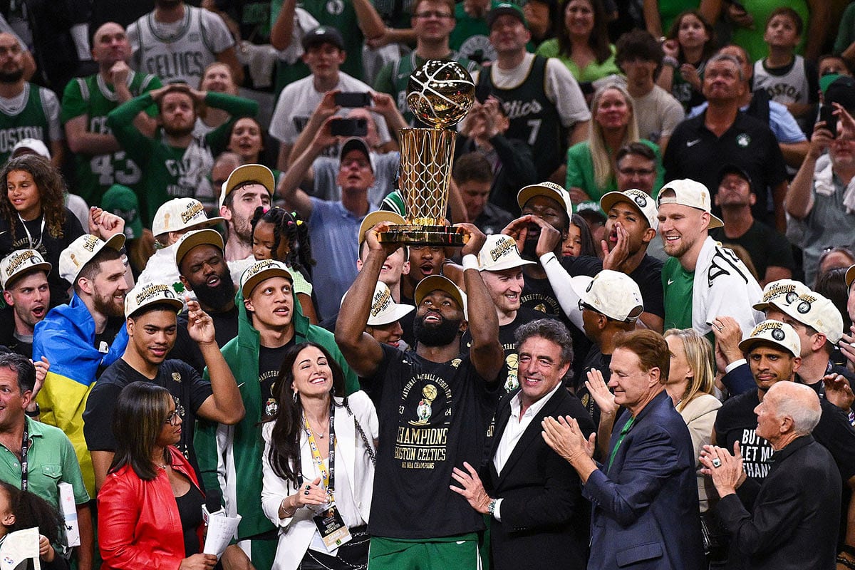 Boston Celtics guard Jaylen Brown (7) holds up the Larry O'Brien Championship Trophy after the Celtics beat the Dallas Mavericks in game five of the 2024 NBA Finals at the TD Garden.