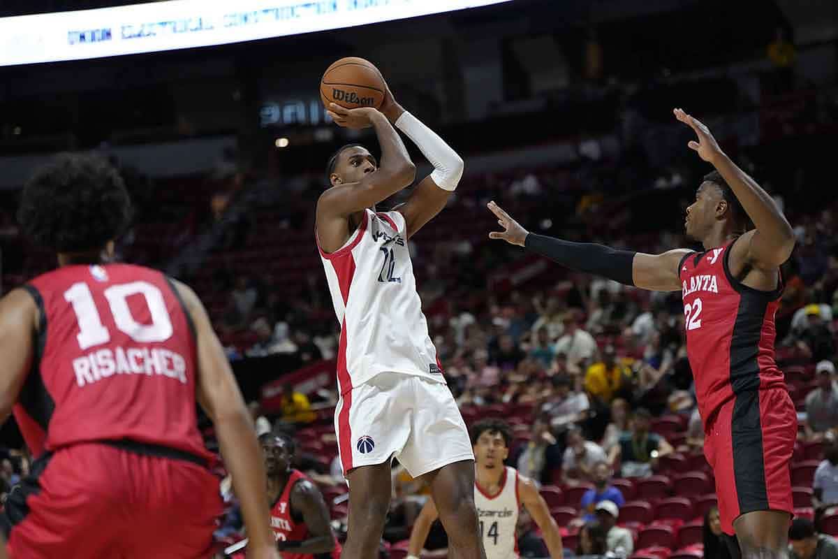 Washington Wizards center Alex Sarr (12) shoots the ball against Atlanta Hawks forwards E.J. Liddell (32) and Zaccharie Risacher (10) during the second half at Thomas & Mack Center.