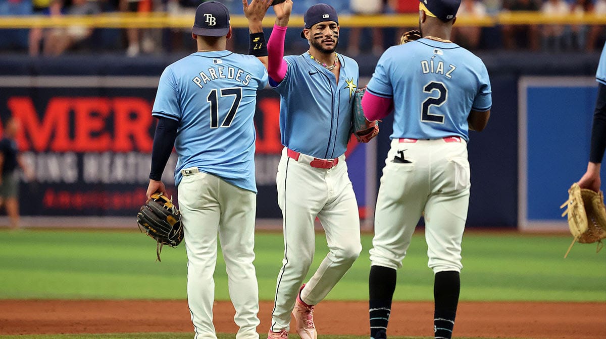 Tampa Bay Rays third base Isaac Paredes (17), outfielder Jose Siri (22) and first base Yandy Diaz (2) high five as they beat the Cleveland Guardians at Tropicana Field.
