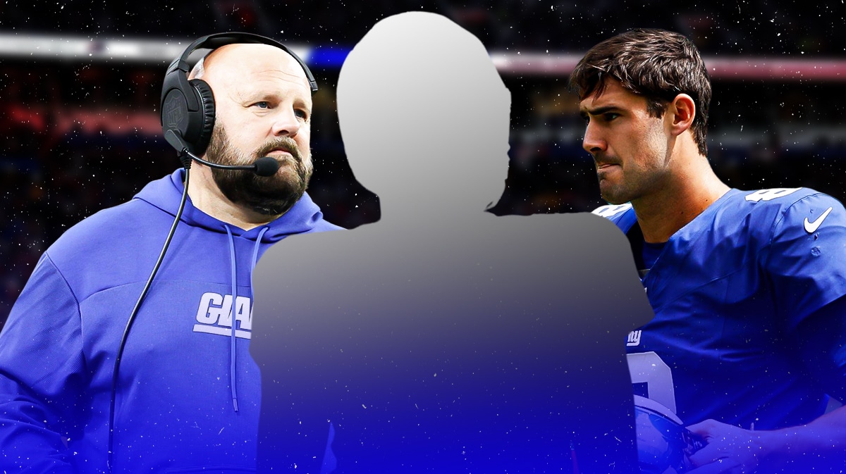 Mystery player in the middle, Coach Brian Daboll and Daniel Jones around him, New York Giants wallpaper in the background
