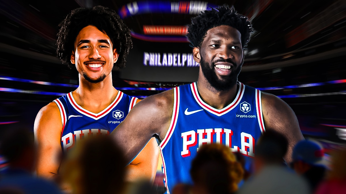 Jared McCain next to Joel Embiid in the Wells Fargo Center.