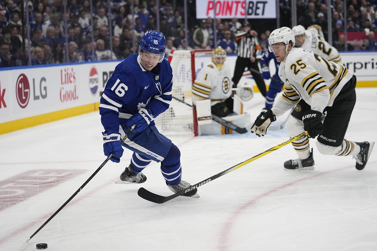  Toronto Maple Leafs forward Mitchell Marner (16) controls the puck as Boston Bruins defenseman Brandon Carlo (25) closes in during the third period of game three of the first round of the 2024 Stanley Cup Playoffs at Scotiabank Arena..