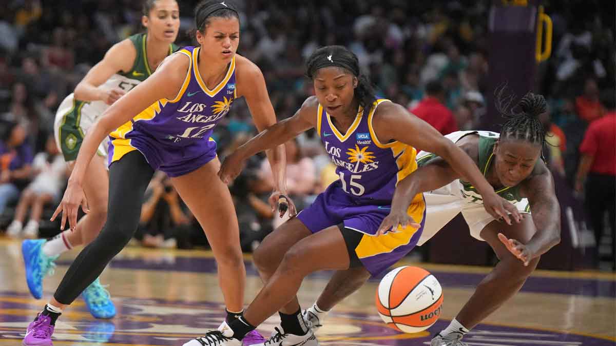 LA Sparks guard Rae Burrell (12) and guard Aari McDonald (15) battle for the ball with Seattle Storm guard Jewell Loyd (24) in the second half at Crypto.com Arena. Mandatory Credit: Kirby Lee-USA TODAY Sports