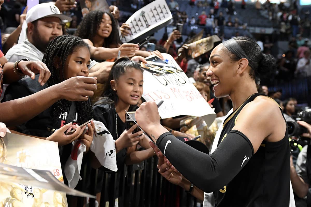 Oct 8, 2023; Las Vegas, Nevada, USA; Las Vegas Aces forward A'ja Wilson (22) signs autographs after game one of the 2023 WNBA Finals against the New York Liberty at Michelob Ultra Arena. Mandatory Credit: Candice Ward-USA TODAY Sports