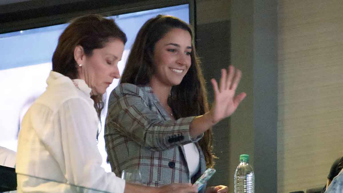 Aly Raisman waves to fans during the U.S. Gymnastics Championships in 2018.