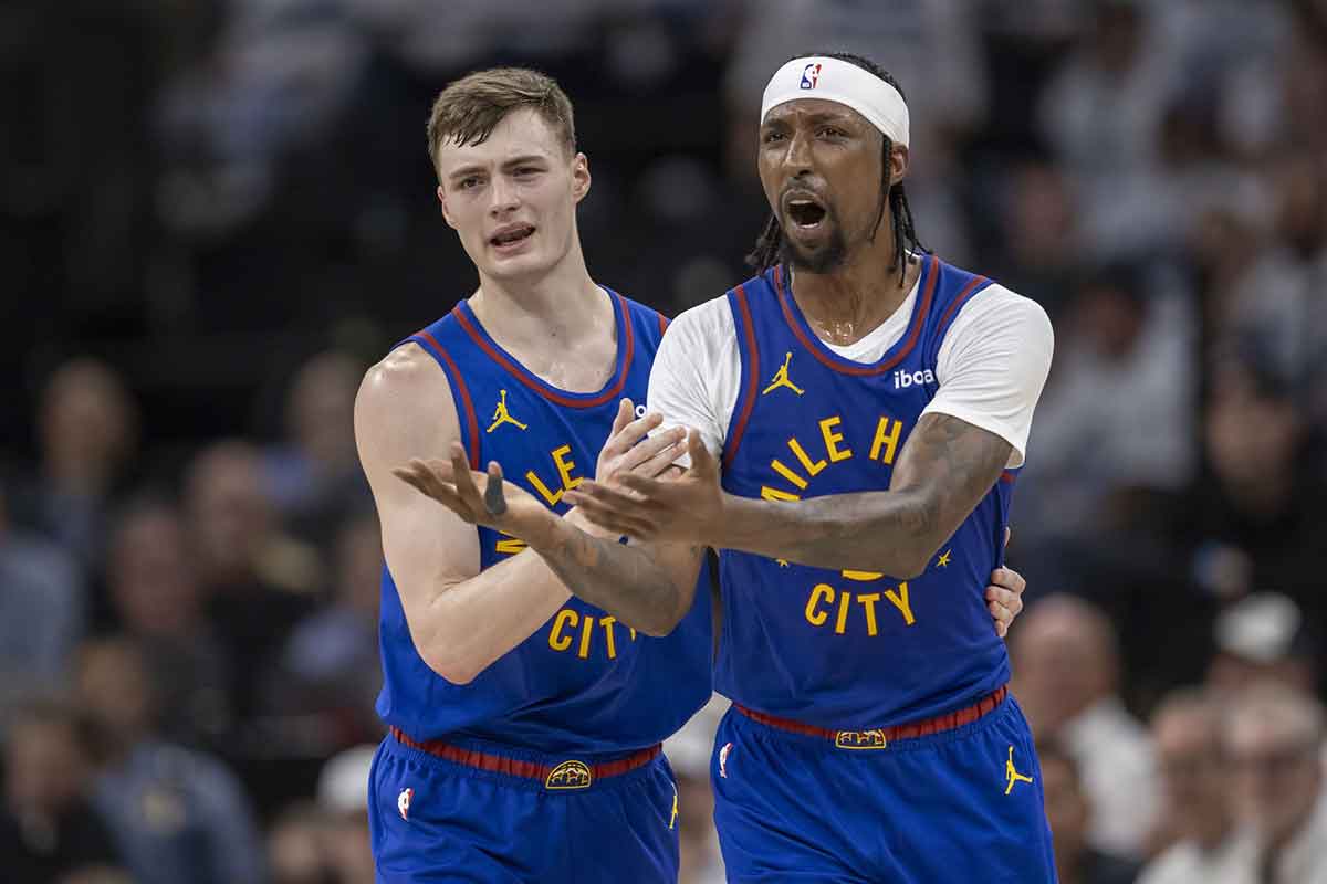 Denver Nuggets guard Christian Braun (0) and Denver Nuggets guard Kentavious Caldwell-Pope (5) react to a call on the court against the Minnesota Timberwolves in the first half during game three of the second round for the 2024 NBA playoffs at Target Center.