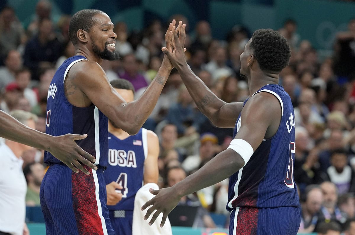 Kevin Durant (7) and guard Anthony Edwards (5) celebrate after a play in the third quarter against Serbia during the Paris 2024 Olympic Summer Games at Stade Pierre-Mauroy. Mandatory Credit: John David Mercer-USA TODAY Sports