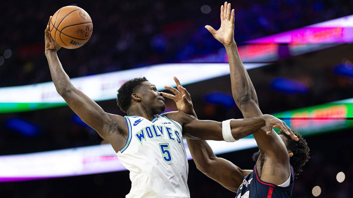 Minnesota Timberwolves guard Anthony Edwards (5) drives for a shot against Philadelphia 76ers center Joel Embiid (21) during the second quarter at Wells Fargo Center. 