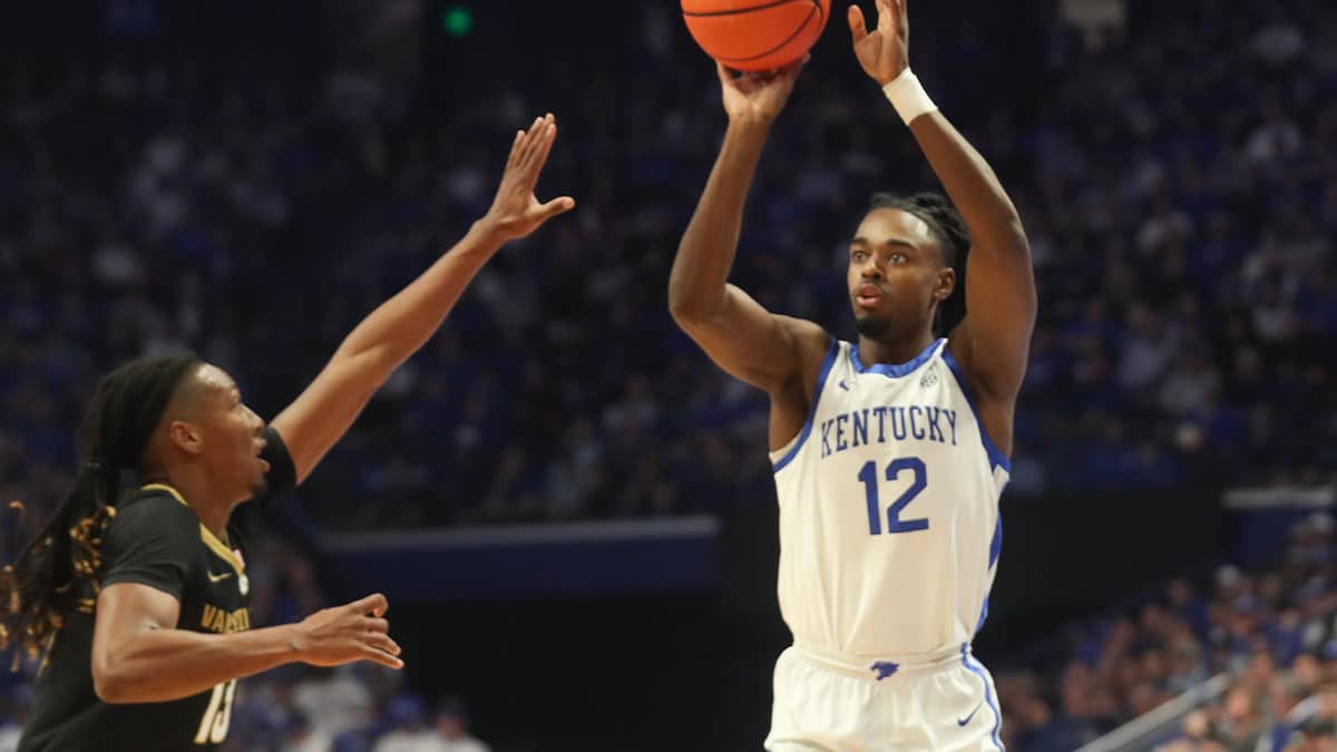 Kentucky's guard Antonio Reeves (12) makes the basket against Vanderbilt's guard Malik Presley (13) during the first half of an NCAA basketball game at Rupp Arena.