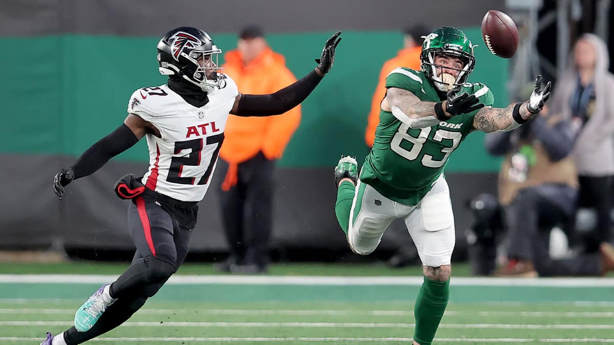 New York Jets tight end Tyler Conklin (83) reaches for an incomplete pass in front of Atlanta Falcons safety Richie Grant (27) during the fourth quarter at MetLife Stadium. 