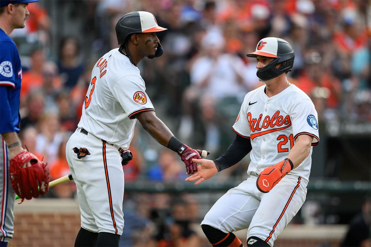 Baltimore Orioles outfielder Austin Hays (21) celebrates with second base Jorge Mateo (3) after scoring a run during the second inning against the Texas Rangers at Oriole Park at Camden Yards. 