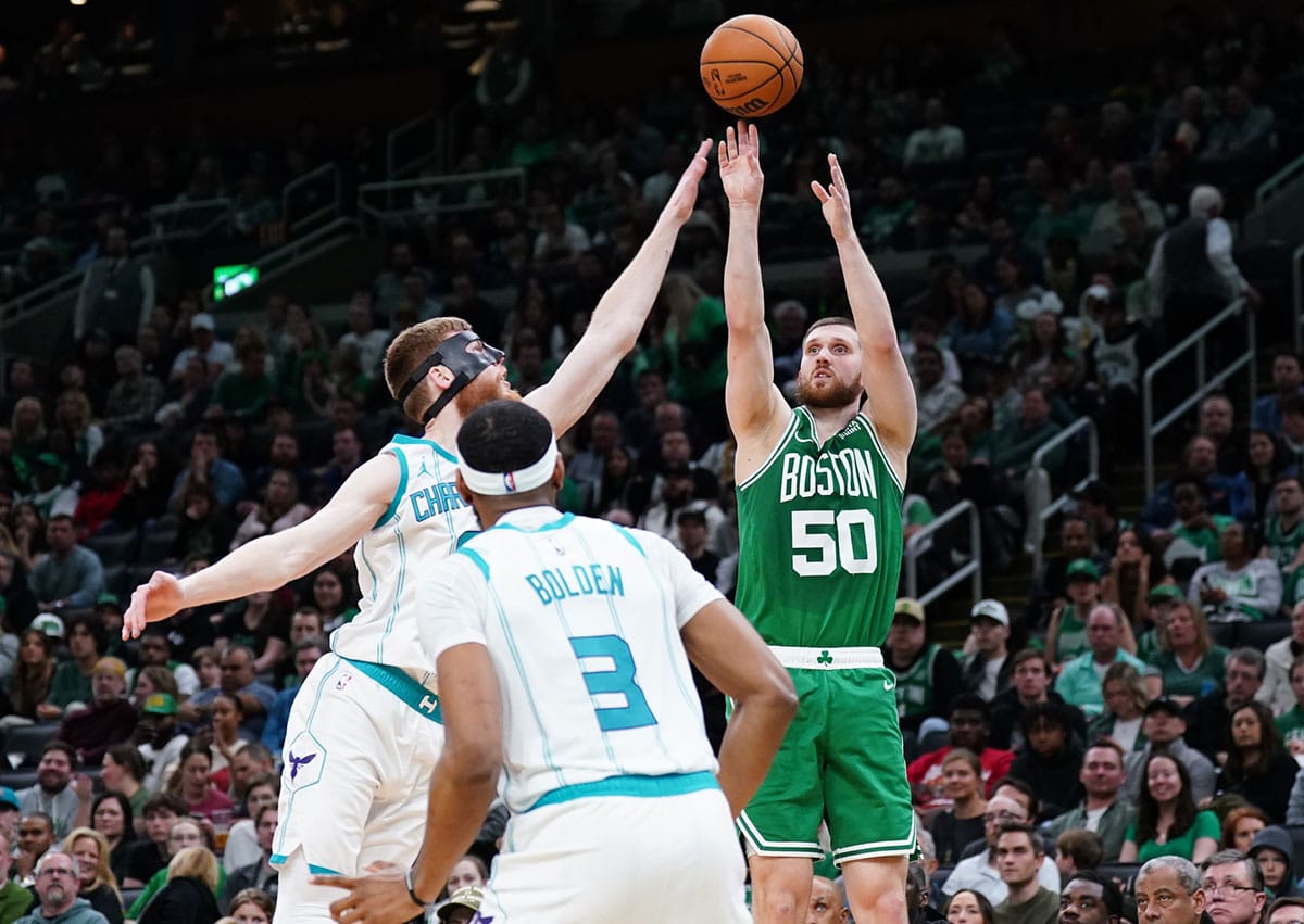 Boston Celtics guard Svi Mykhailiuk (50) shoots against Charlotte Hornets forward Davis Bertans (9) in the second quarter at TD Garden.