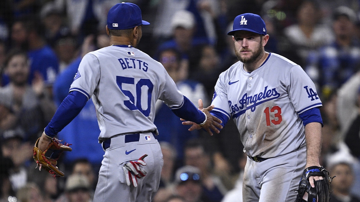 May 11, 2024; San Diego, California, USA; Los Angeles Dodgers third baseman Max Muncy (13) is congratulated by Los Angeles Dodgers shortstop Mookie Betts (50) after a defensive play against the San Diego Padres to end the eighth inning at Petco Park. 