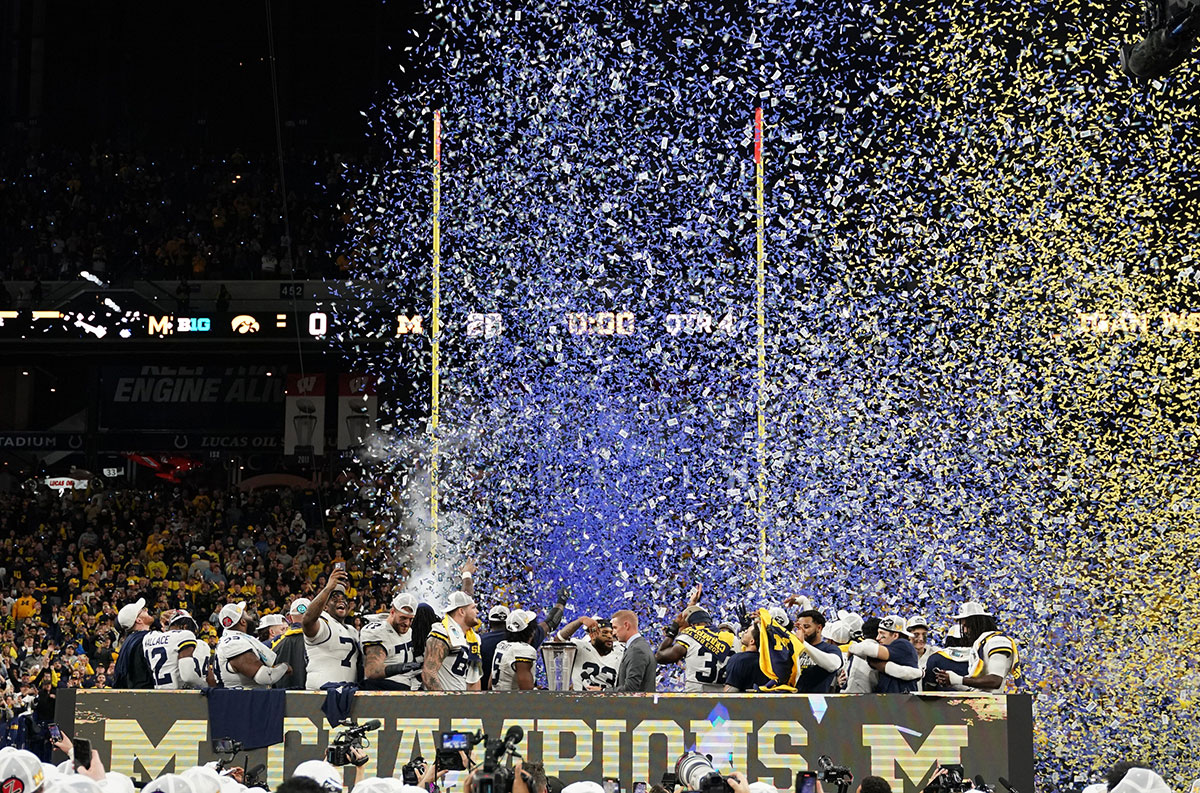 Michigan Wolverines celebrate after winning the Big Ten Championship game against the Iowa Hawkeyes at Lucas Oil Stadium.