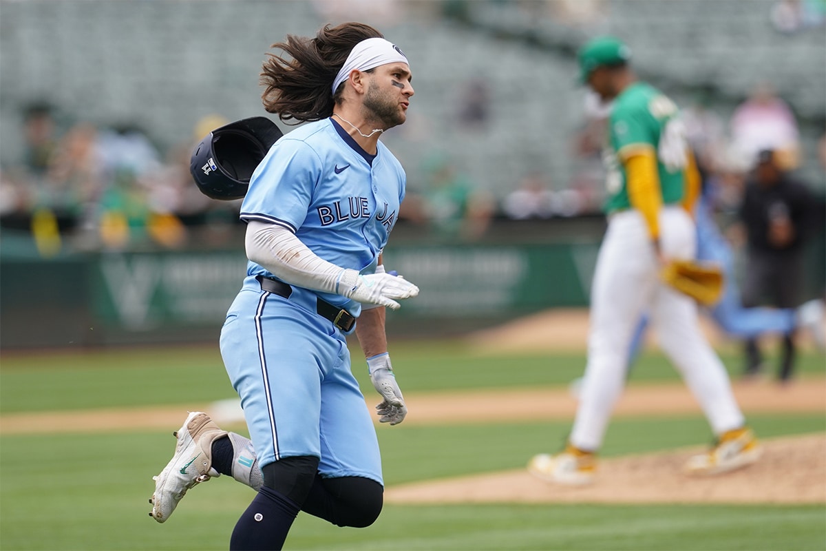 Toronto Blue Jays shortstop Bo Bichette (11) runs towards first base after hitting an RBI double against the Oakland Athletics in the fifth inning at Oakland-Alameda County Coliseum.