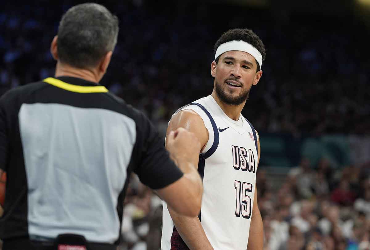 United States guard Devin Booker (15) talks to an official in the fourth quarter against South Sudan during the Paris 2024 Olympic Summer Games at Stade Pierre-Mauroy.