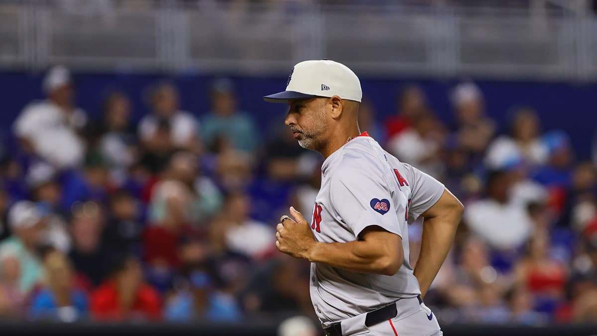 Jul 4, 2024; Miami, Florida, USA; Boston Red Sox manager Alex Cora (13) runs to the dugout during the eighth inning against the Miami Marlins at loanDepot Park. Mandatory Credit: Sam Navarro-USA TODAY Sports