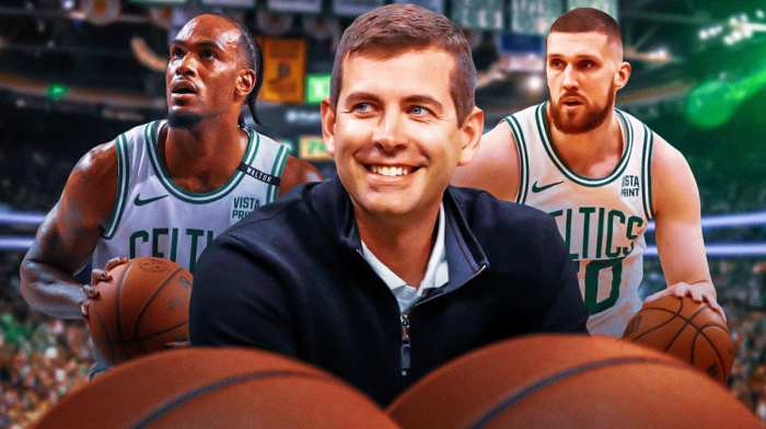 Brad Stevens with Oshae Brissett and Svi Mykhailiuk on either side of him in Celtics jerseys
