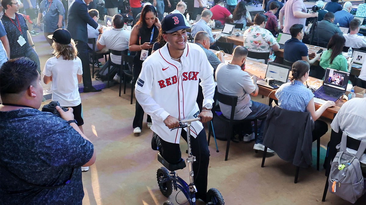 Braden Montgomery reacts while riding a scooter after he was drafted by the Boston Red Sox with the twelfth pick during the first round of the MLB Draft at Cowtown Coliseum.
