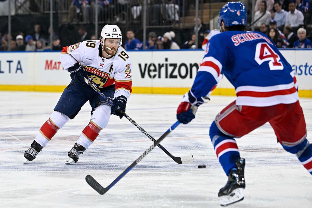 Florida Panthers left wing Matthew Tkachuk (19) skates with the puck as New York Rangers defenseman Braden Schneider (4) defends during the second period in game five of the Eastern Conference Final of the 2024 Stanley Cup Playoffs at Madison Square Garden.