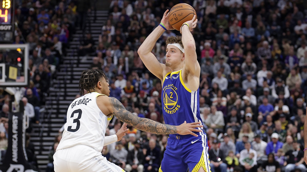 Golden State Warriors guard Brandin Podziemski (2) protects the ball from Utah Jazz guard Keyonte George (3) during the second half at Delta Center. 