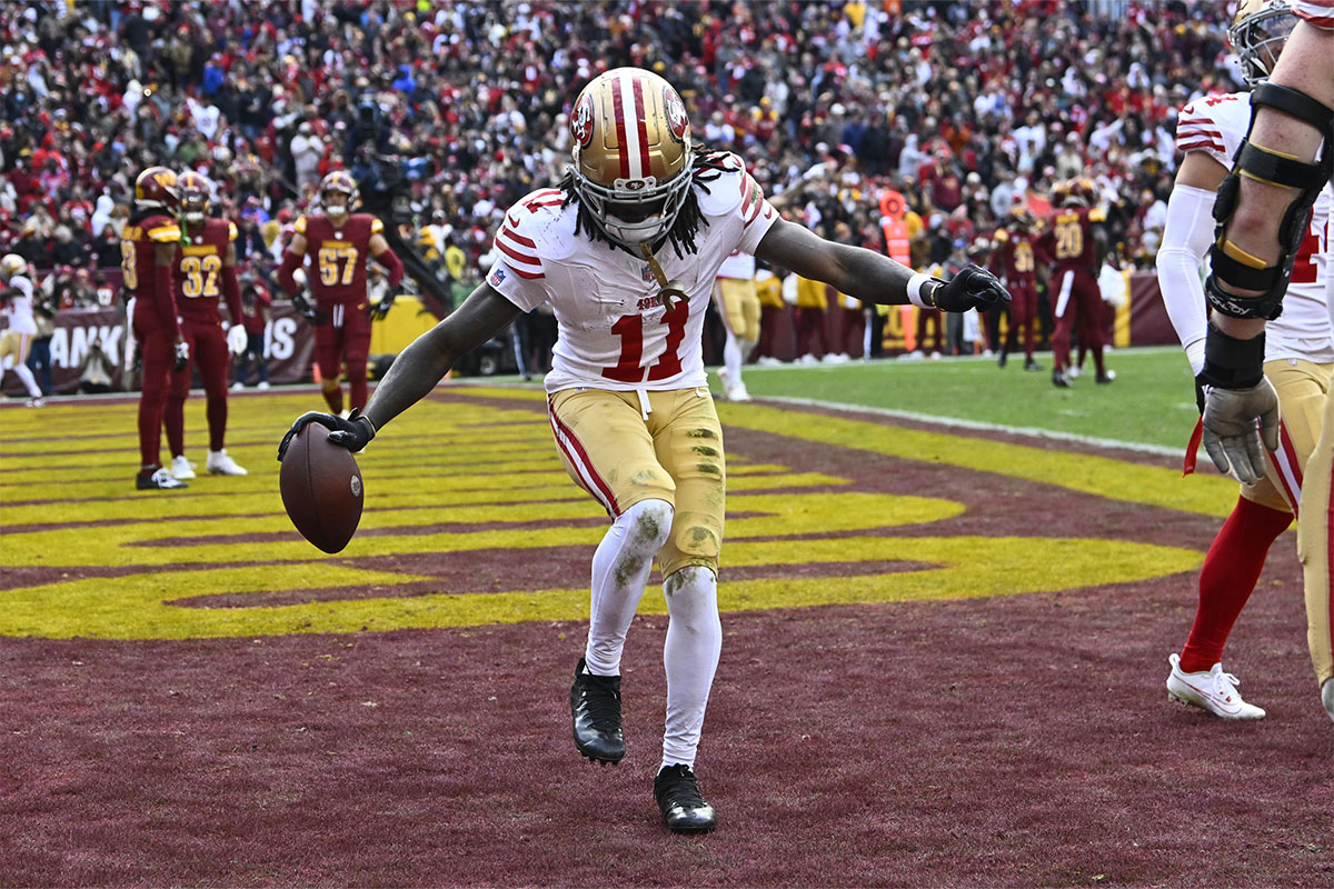 San Francisco 49ers wide receiver Brandon Aiyuk (11) celebrates after scoring a touchdown against the Washington Commanders during the second half at FedExField. 