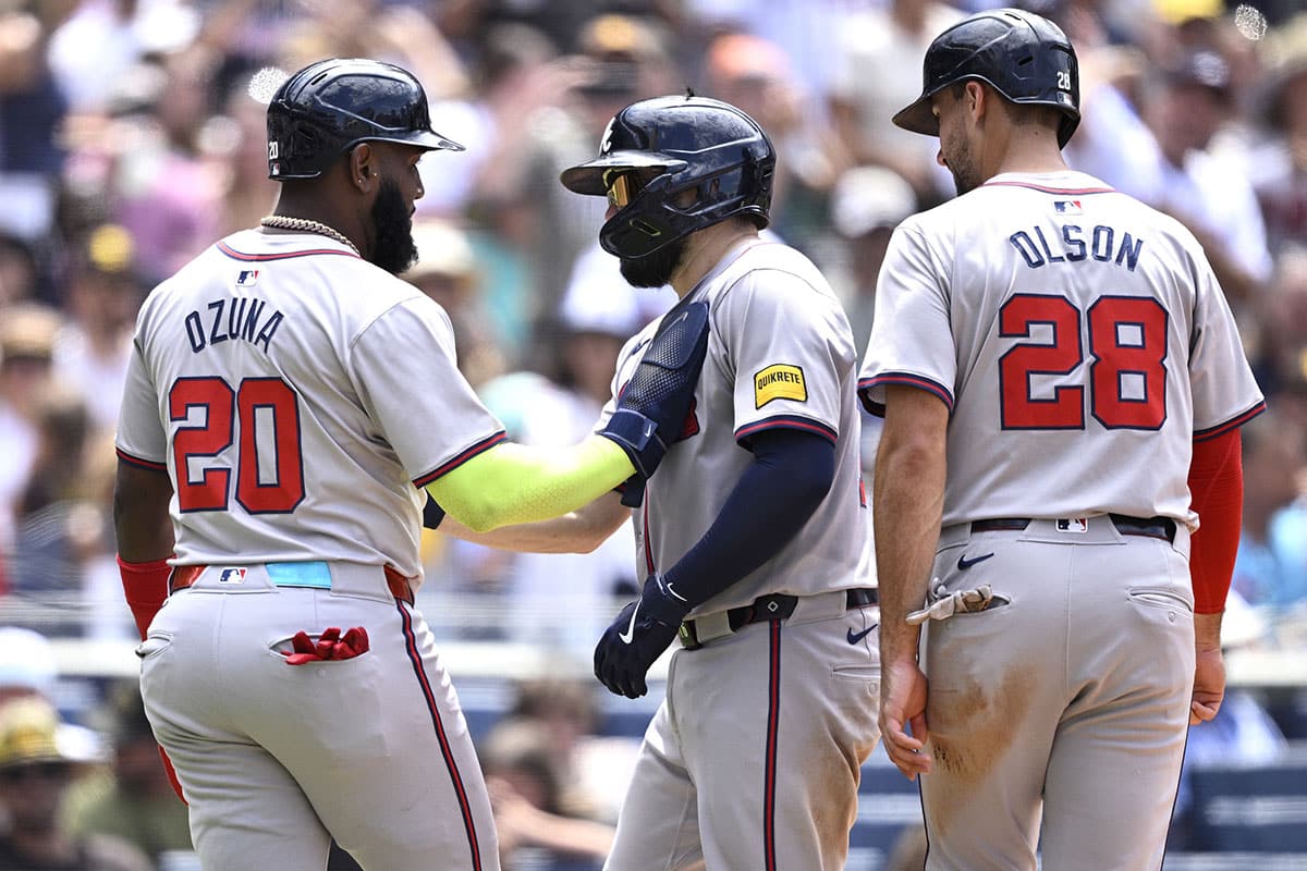 Atlanta Braves catcher Travis d'Arnaud (center) is congratulated by designated hitter Marcell Ozuna (20) and first baseman Matt Olson (28) after hitting a three-run home run against the San Diego Padres during the sixth inning at Petco Park.