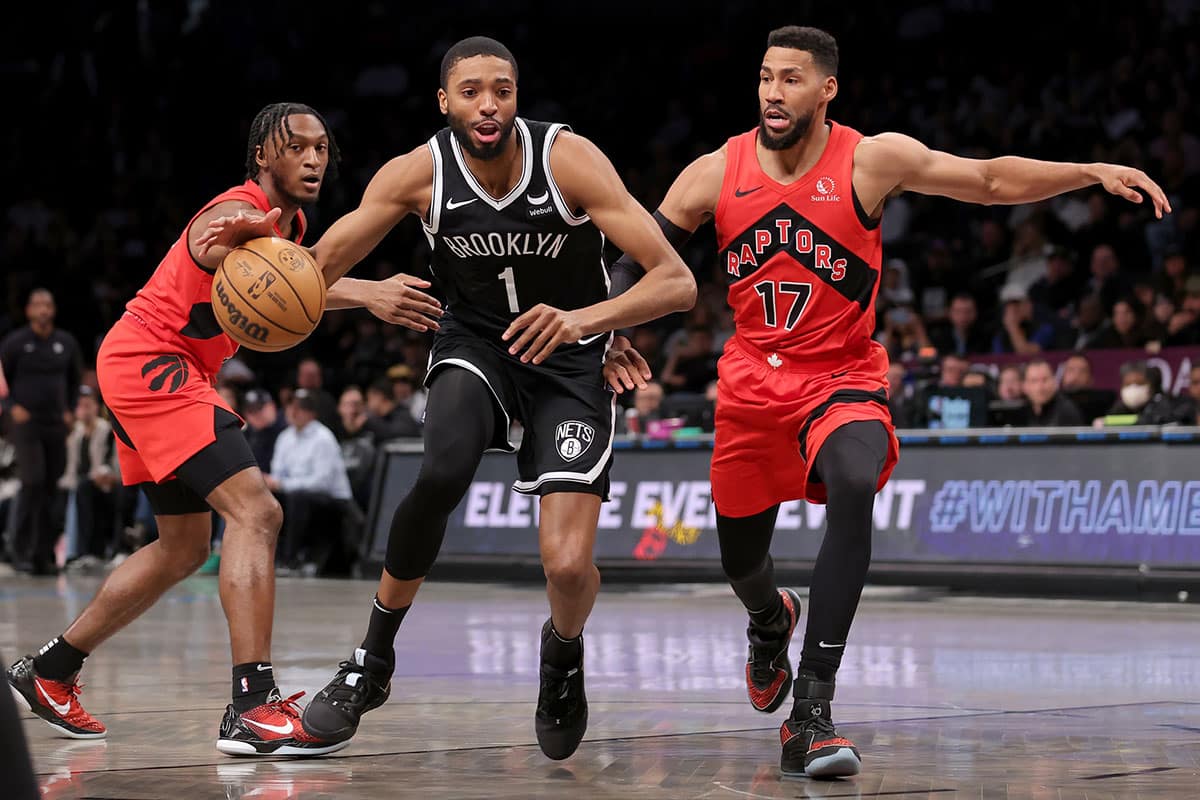 Brooklyn Nets forward Mikal Bridges (1) drives to the basket between Toronto Raptors guard Immanuel Quickley (5) and forward Garrett Temple (17) during the first quarter at Barclays Center. 