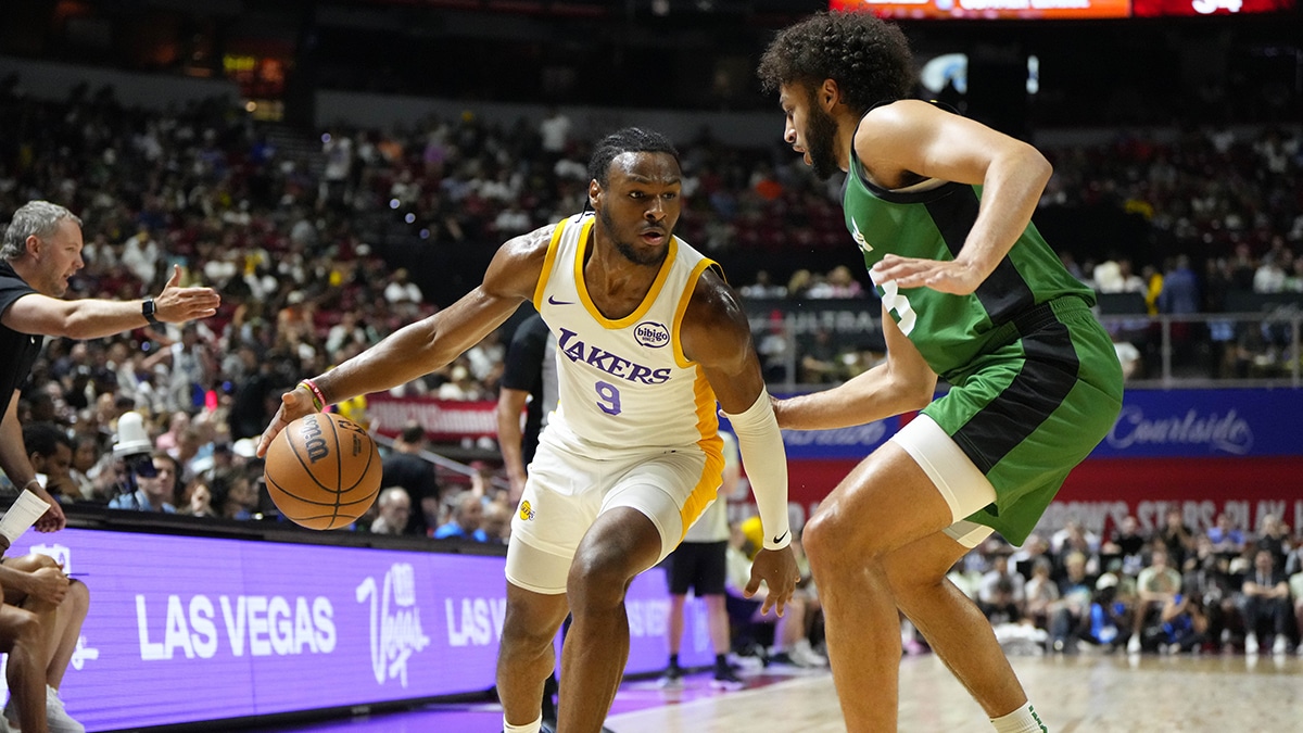 Los Angeles Lakers guard Bronny James (9) dribbles the ball against Boston Celtics forward Anton Watson (28) during the first half at Thomas & Mack Center.