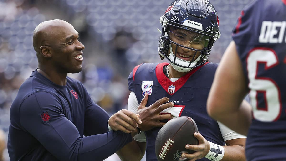 Houston Texans head coach DeMeco Ryans laughs with quarterback C.J. Stroud (7) before the game against the New Orleans Saints at NRG Stadium.
