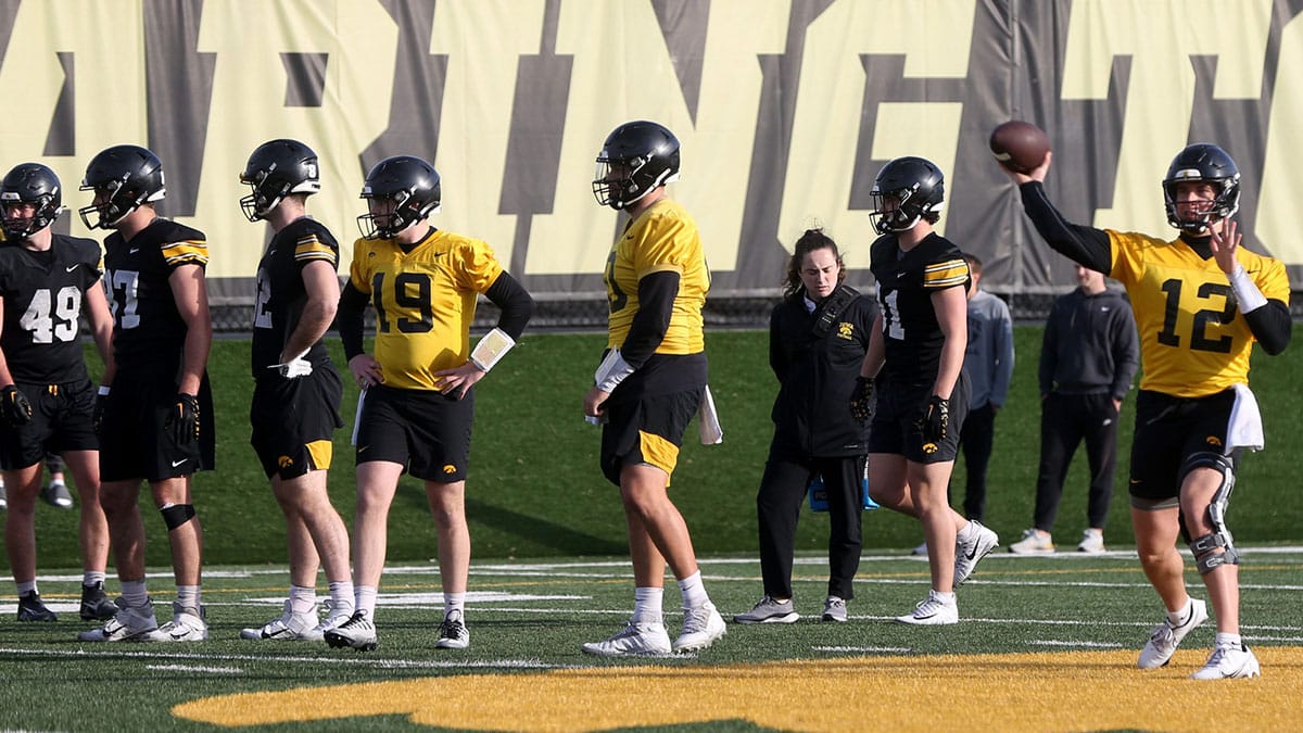 Iowa quarterback Cade McNamara (12) throws a pass during practice