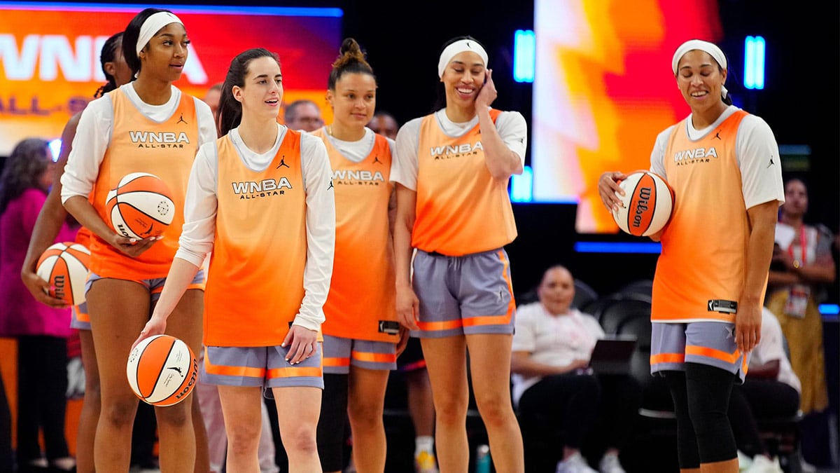 July 19, 2024; Phoenix, Ariz., U.S.; Sky forward Angel Reese (L) and Fever guard Caitlin Clark (second from left) stand with their teammates as they shoot half court shots during WNBA All-Star practice on Media Day at the Footprint Center.