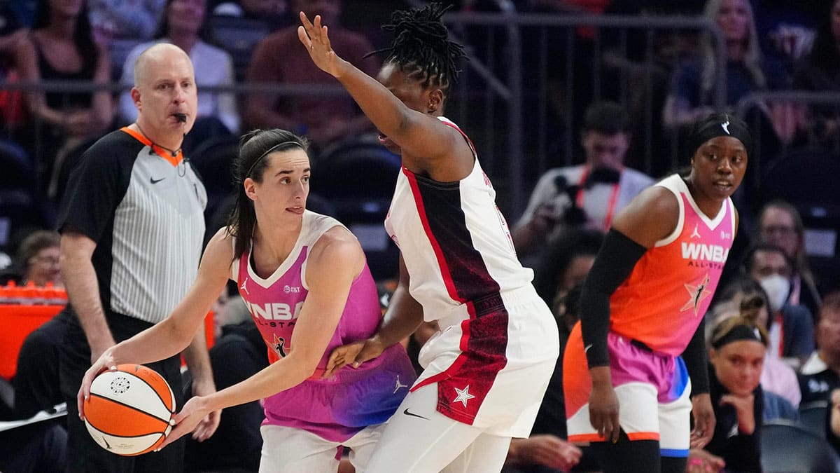 Team WNBA guard Caitlin Clark looks for an open teammate against Team USA guard Chelsea Gray during the WNBA All-Star Game at Footprint Center in Phoenix on July 20, 2024.