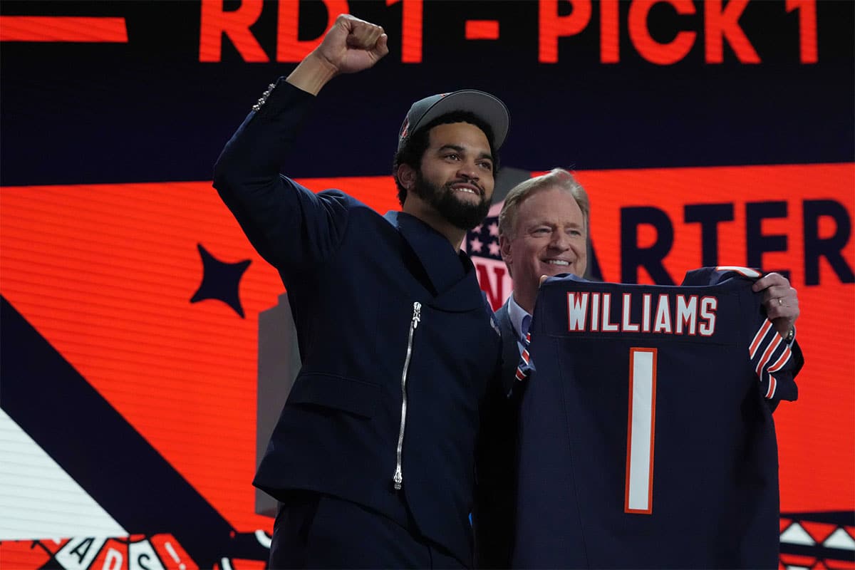 Southern California Trojans quarterback Caleb Williams poses with jersey and NFL commissioner Roger Goodell after being chosen as the No. 1 pick in the first round during the 2024 NFL Draft at Campus Martius Park and Hart Plaza.