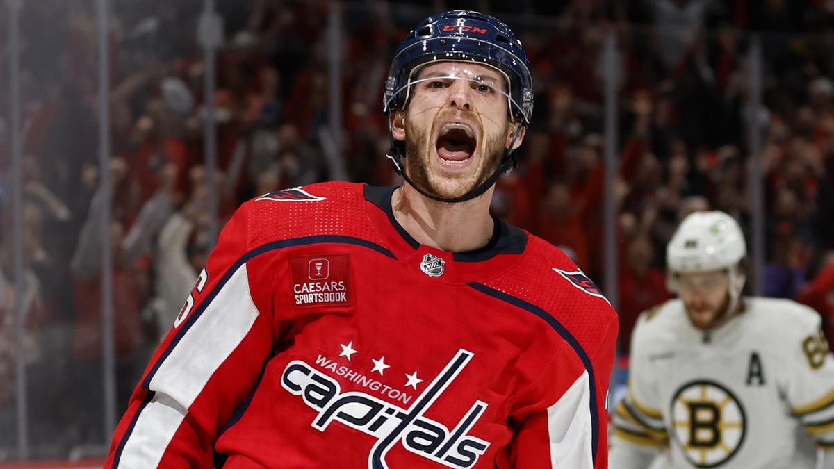 Washington Capitals center Nic Dowd (26) celebrates after scoring an empty net goal as Boston Bruins right wing David Pastrnak (88) looks on in the final minute of the third period at Capital One Arena.