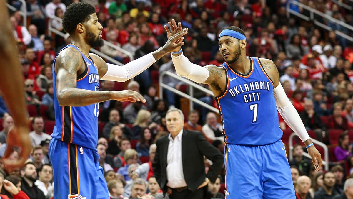 Oklahoma City Thunder forward Carmelo Anthony (7) celebrates with forward Paul George (13) after a play during the third quarter against the Houston Rockets at Toyota Center. 