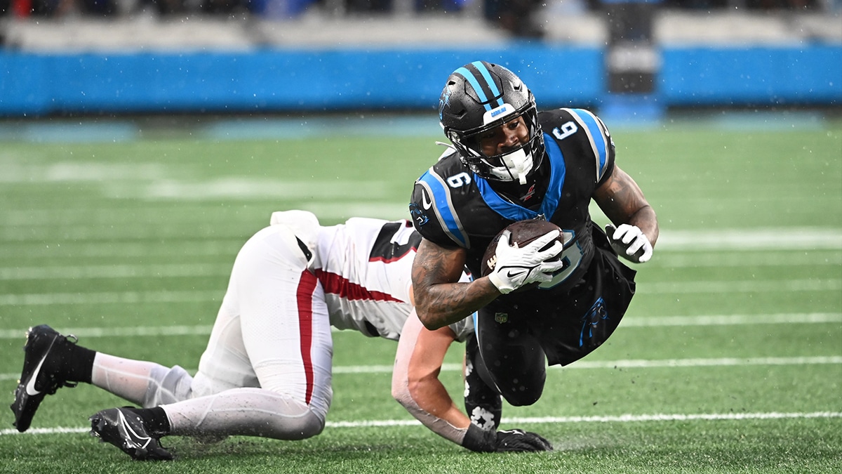 Carolina Panthers running back Miles Sanders (6) with the ball as Atlanta Falcons linebacker Nate Landman (53) defends in the fourth quarter at Bank of America Stadium.