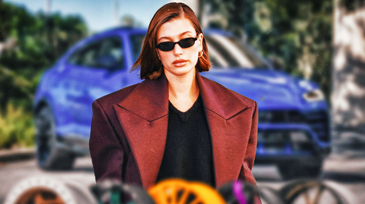 Hailey Bieber in front of a car from her collection.