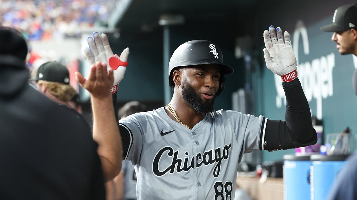 Chicago White Sox center fielder Luis Robert Jr. (88) celebrates with teammates in the dugout after hitting a home run during the third inning against the Texas Rangers at Globe Life Field.