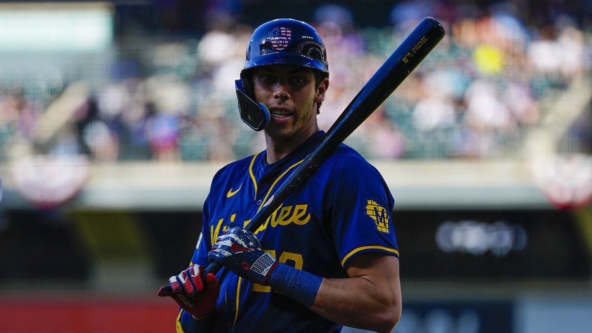 Milwaukee Brewers left fielder Christian Yelich (22) wears 4th of July colors against the Colorado Rockies during the first inning at Coors Field.